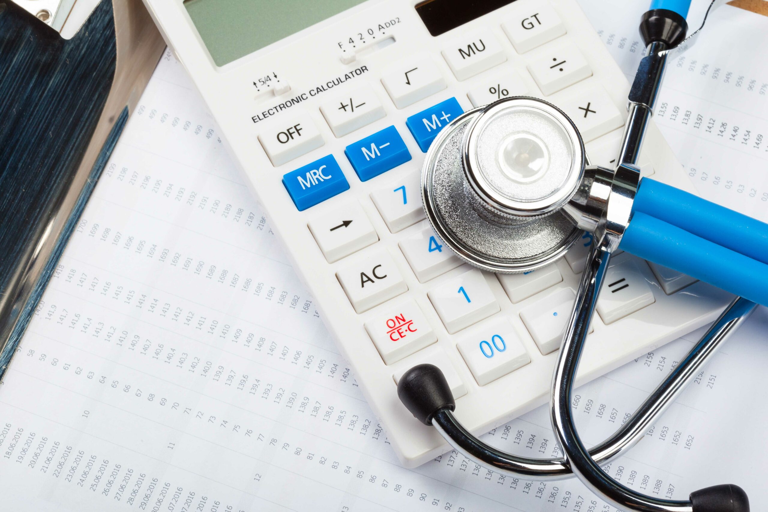 Health care costs. Stethoscope and calculator