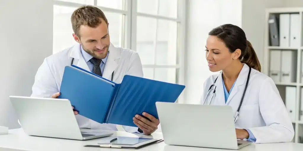 Doctors performing a documentation review for sleep and neurology billing solutions.