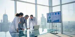 Healthcare professionals analyzing data from a claims processing company.